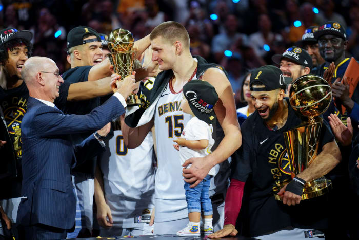 NBA commissioner Adam Silver awards Nikola Jokić with the NBA Finals MVP award.